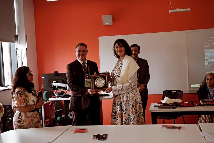 Receiving the keynote speaker plaque from the ICDAM 2026 organising committee